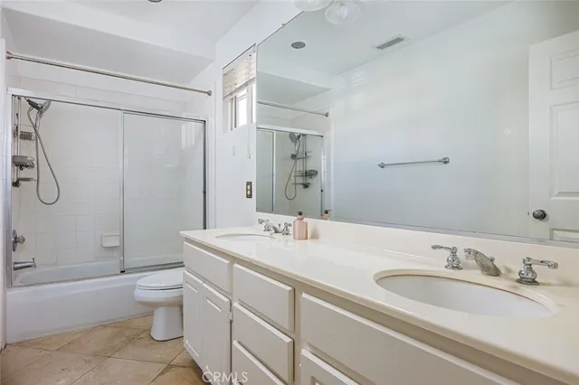 a view of a patio with couches table and chairs and potted plants