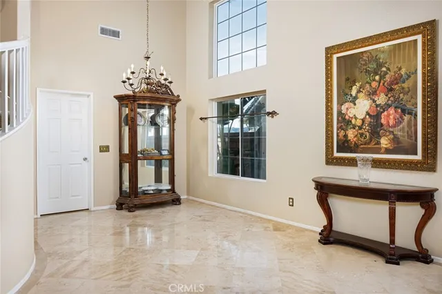 a kitchen with stainless steel appliances granite countertop a stove a sink and white cabinets