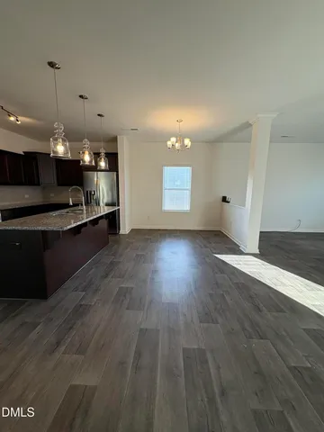 a view of wooden floor and window in a room