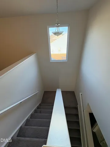 a spacious bathroom with a double vanity sink a large mirror and a shower
