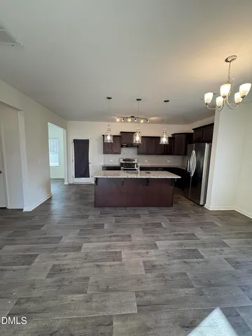 a view of a kitchen with a sink stainless steel appliances and cabinets