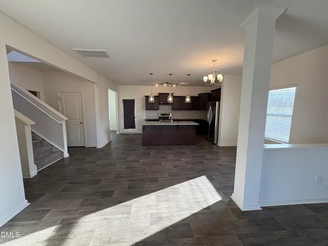 a kitchen with granite countertop wooden cabinets and stainless steel appliances