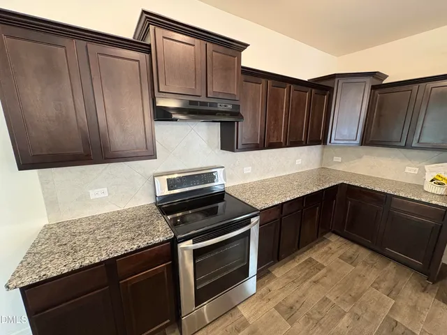 a large kitchen with kitchen island a large counter space a sink appliances and cabinets