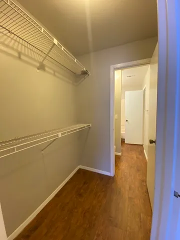 a view of a room with wooden floor