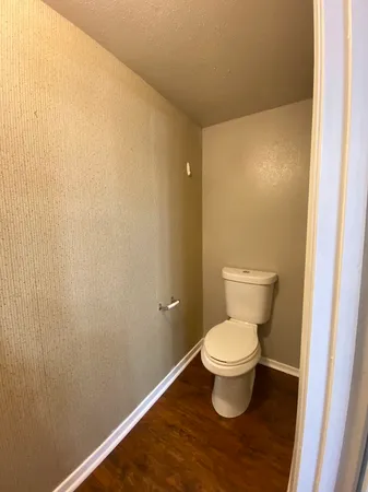 a white toilet sitting in a bathroom and a sink