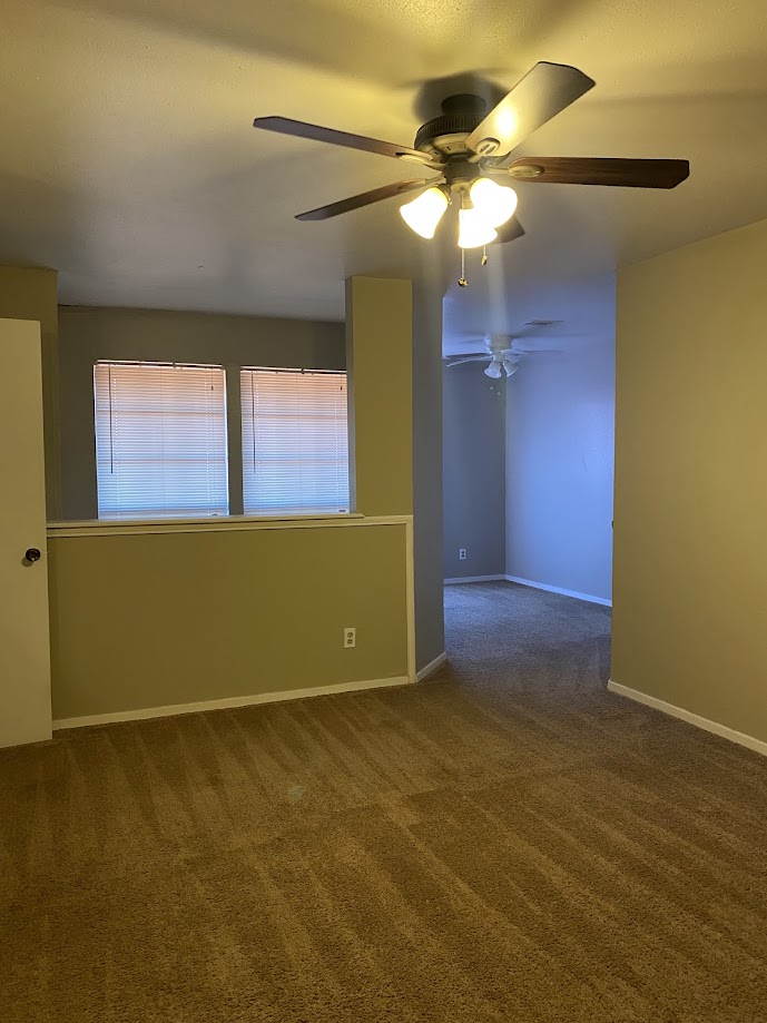 1305 West Villa Maria Road, Unit B104 Bryan, TX 77801 - Photo 7 of 14 an empty room with a window and chandelier