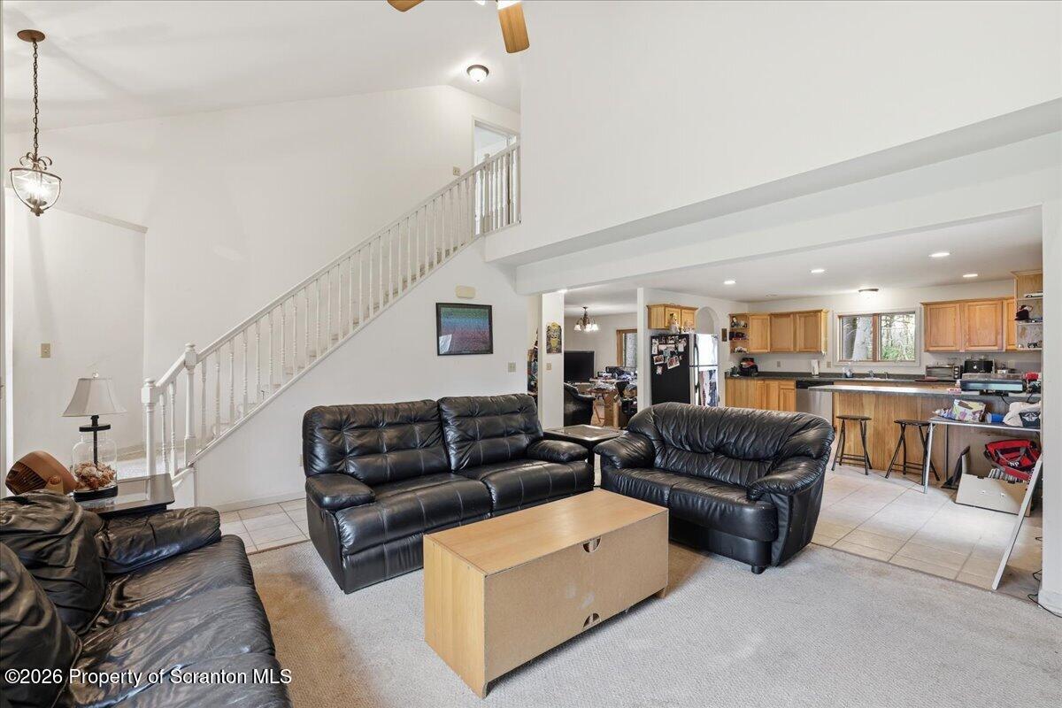 381 Goose Pond Road Lake Ariel, PA 18436 - Photo 12 of 81 a living room with furniture kitchen view and a chandelier