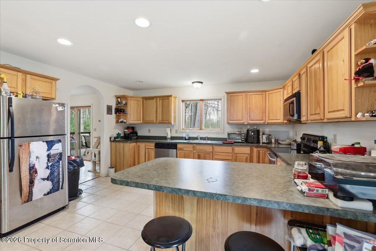 381 Goose Pond Road Lake Ariel, PA 18436 - Photo 19 of 81 a kitchen with stainless steel appliances granite countertop a sink refrigerator and cabinets