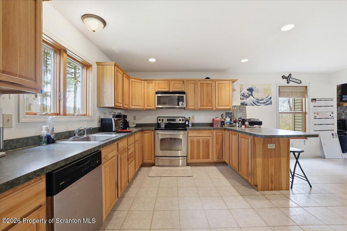 381 Goose Pond Road Lake Ariel, PA 18436 - Photo 20 of 81 a large kitchen with stainless steel appliances granite countertop a stove sink and cabinets