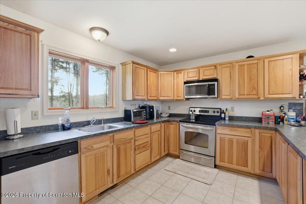 381 Goose Pond Road Lake Ariel, PA 18436 - Photo 21 of 81 a kitchen with sink a window and appliances