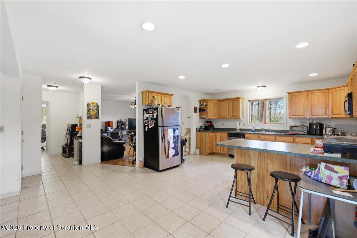 381 Goose Pond Road Lake Ariel, PA 18436 - Photo 25 of 81 a kitchen with stainless steel appliances kitchen island granite countertop a refrigerator and cabinets