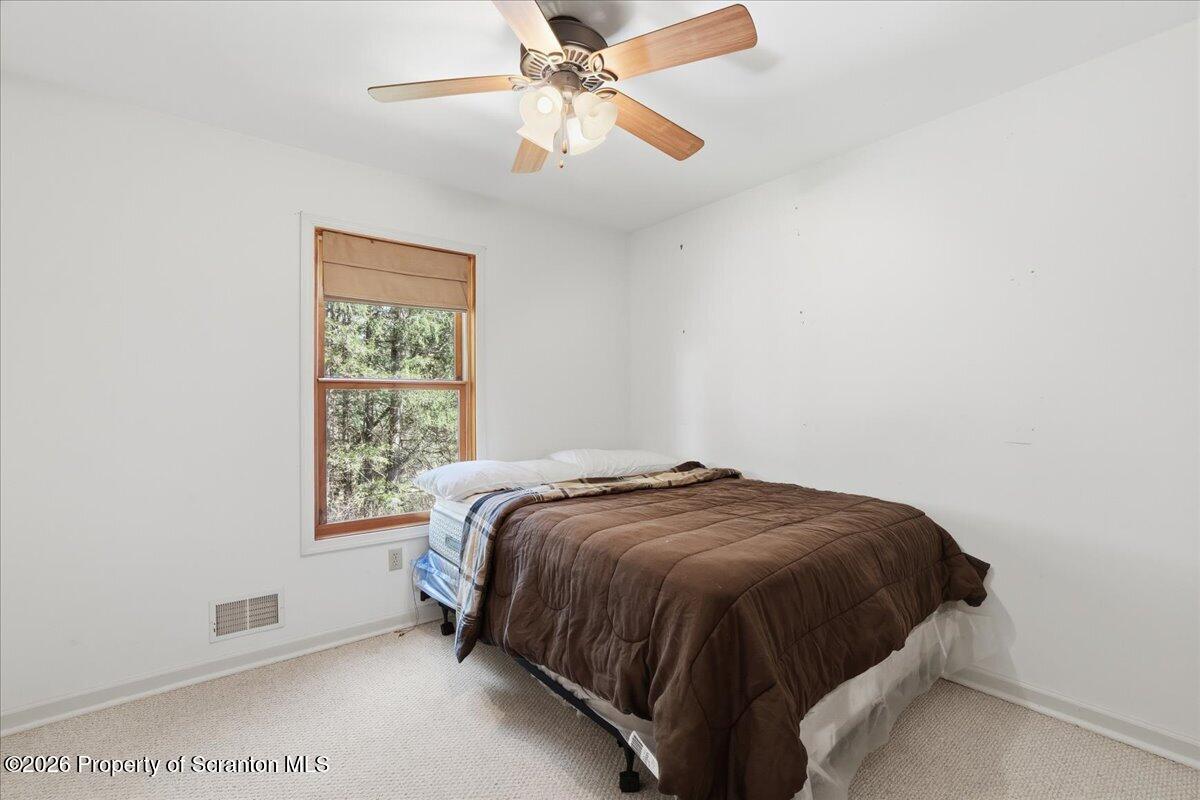 381 Goose Pond Road Lake Ariel, PA 18436 - Photo 31 of 81 a bedroom with a bed and a ceiling fan