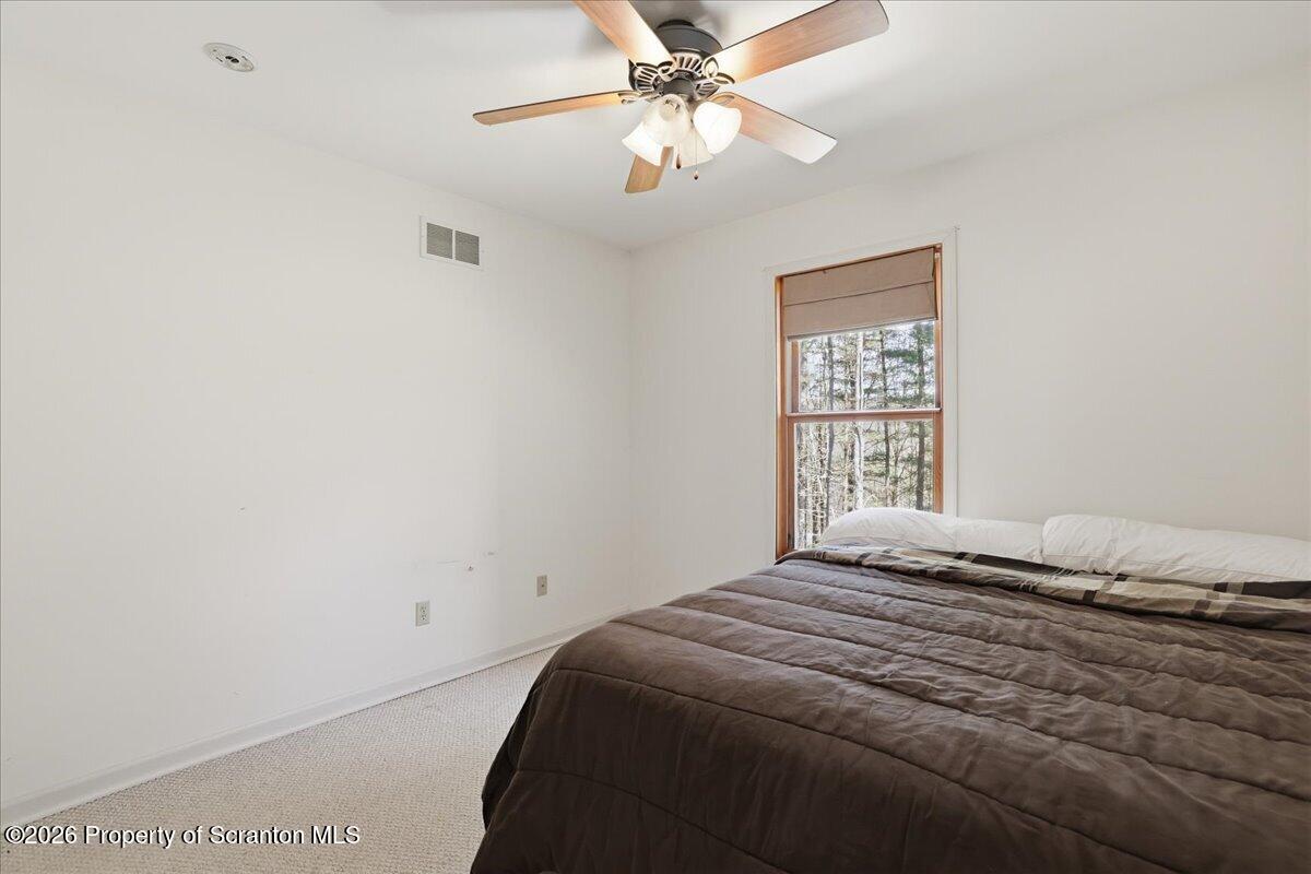 381 Goose Pond Road Lake Ariel, PA 18436 - Photo 33 of 81 a bedroom with a bed and a window