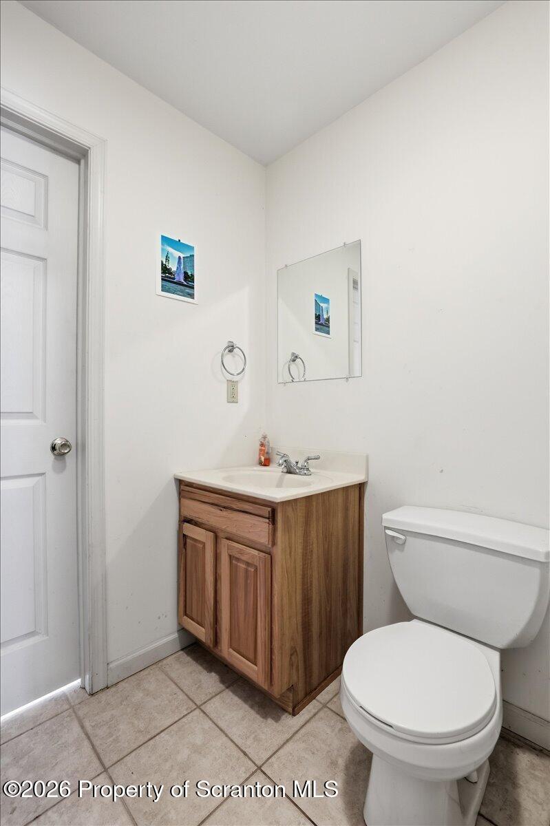 381 Goose Pond Road Lake Ariel, PA 18436 - Photo 42 of 81 a bathroom with a toilet a sink and mirror