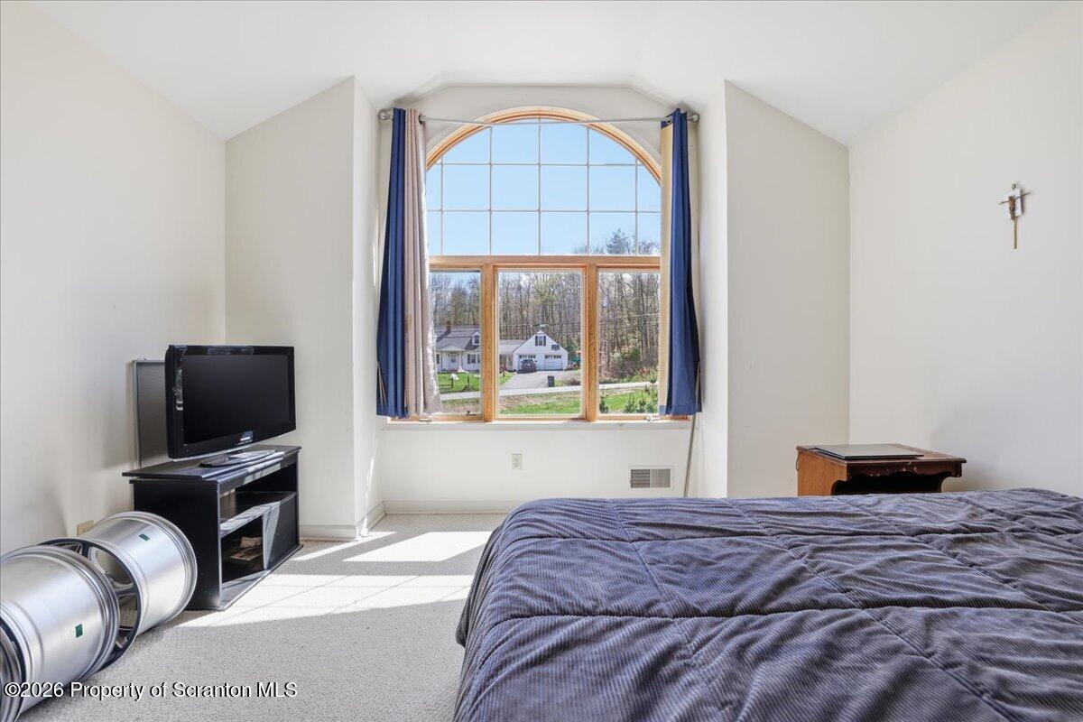 381 Goose Pond Road Lake Ariel, PA 18436 - Photo 45 of 81 a bedroom with a bed and a flat screen tv