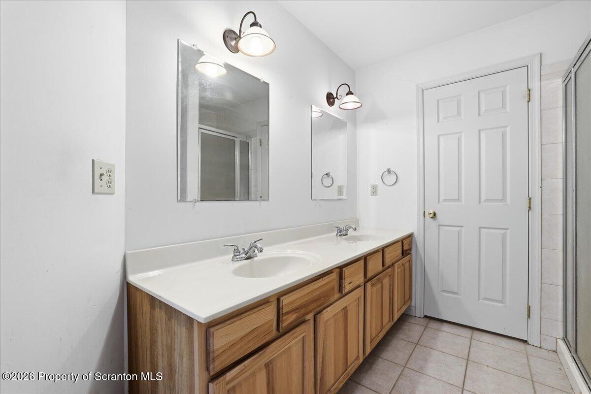 381 Goose Pond Road Lake Ariel, PA 18436 - Photo 48 of 81 a bathroom with a sink a mirror and a shower