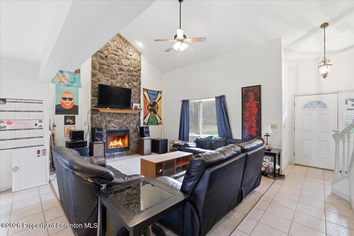 381 Goose Pond Road Lake Ariel, PA 18436 - Photo 6 of 81 a living room with furniture a fireplace and a flat screen tv