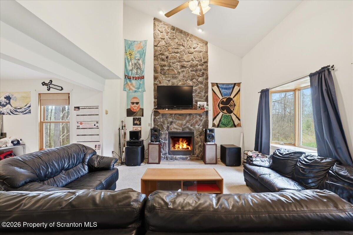 381 Goose Pond Road Lake Ariel, PA 18436 - Photo 7 of 81 a living room with furniture a fireplace and a flat screen tv