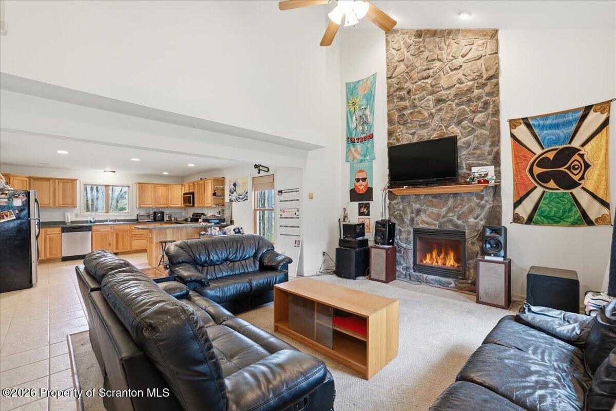 381 Goose Pond Road Lake Ariel, PA 18436 - Photo 8 of 81 a living room with furniture a flat screen tv and a fireplace