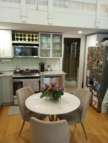 a view of a dining room with furniture and wooden floor