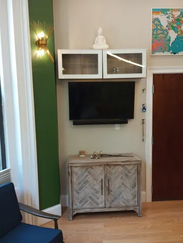 a living room with flat screen tv and a fireplace