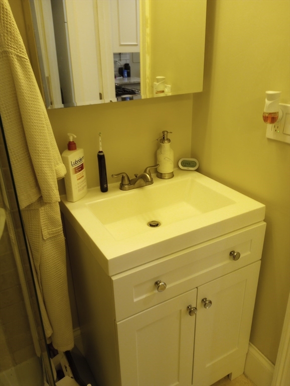 290 Columbus Avenue, Unit 4 Boston, MA 02116 - Photo 10 of 11 a bathroom with a sink and a washer dryer