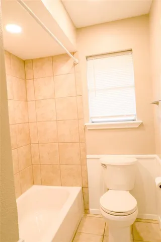 a bathroom with a toilet and a bathtub