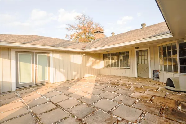 a view of backyard with wooden fence