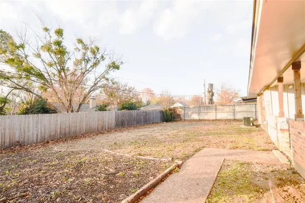 a front view of house with yard and trees around