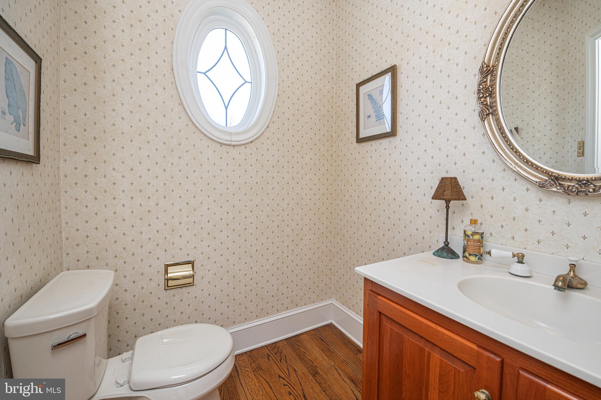 516 Sugartown Road Devon, PA 19333 - Photo 13 of 77 a bathroom with a toilet a sink and mirror