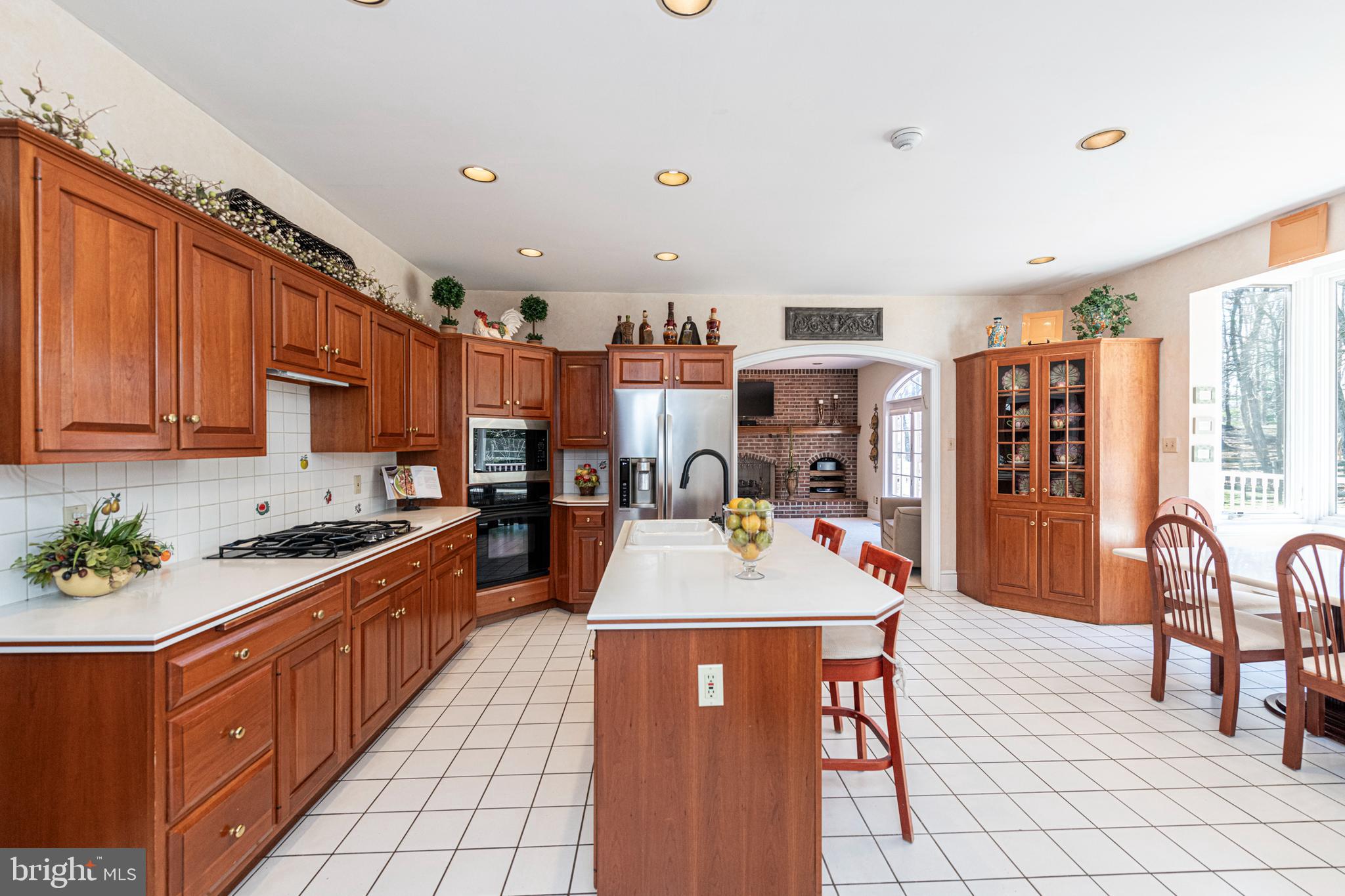 516 Sugartown Road Devon, PA 19333 - Photo 30 of 77 a kitchen with stainless steel appliances granite countertop a stove top oven a sink dishwasher and cabinets with wooden floor