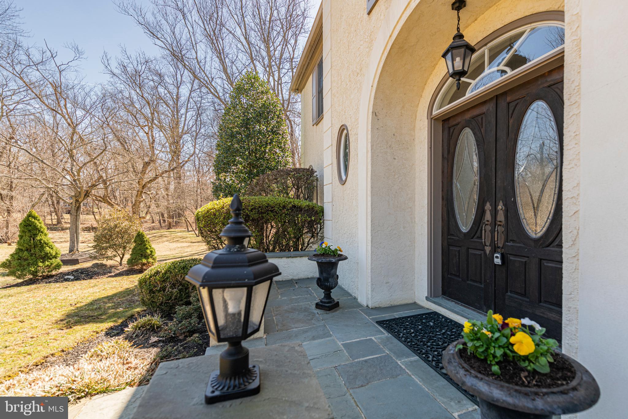 516 Sugartown Road Devon, PA 19333 - Photo 3 of 77 a view of a porch with furniture and potted plants