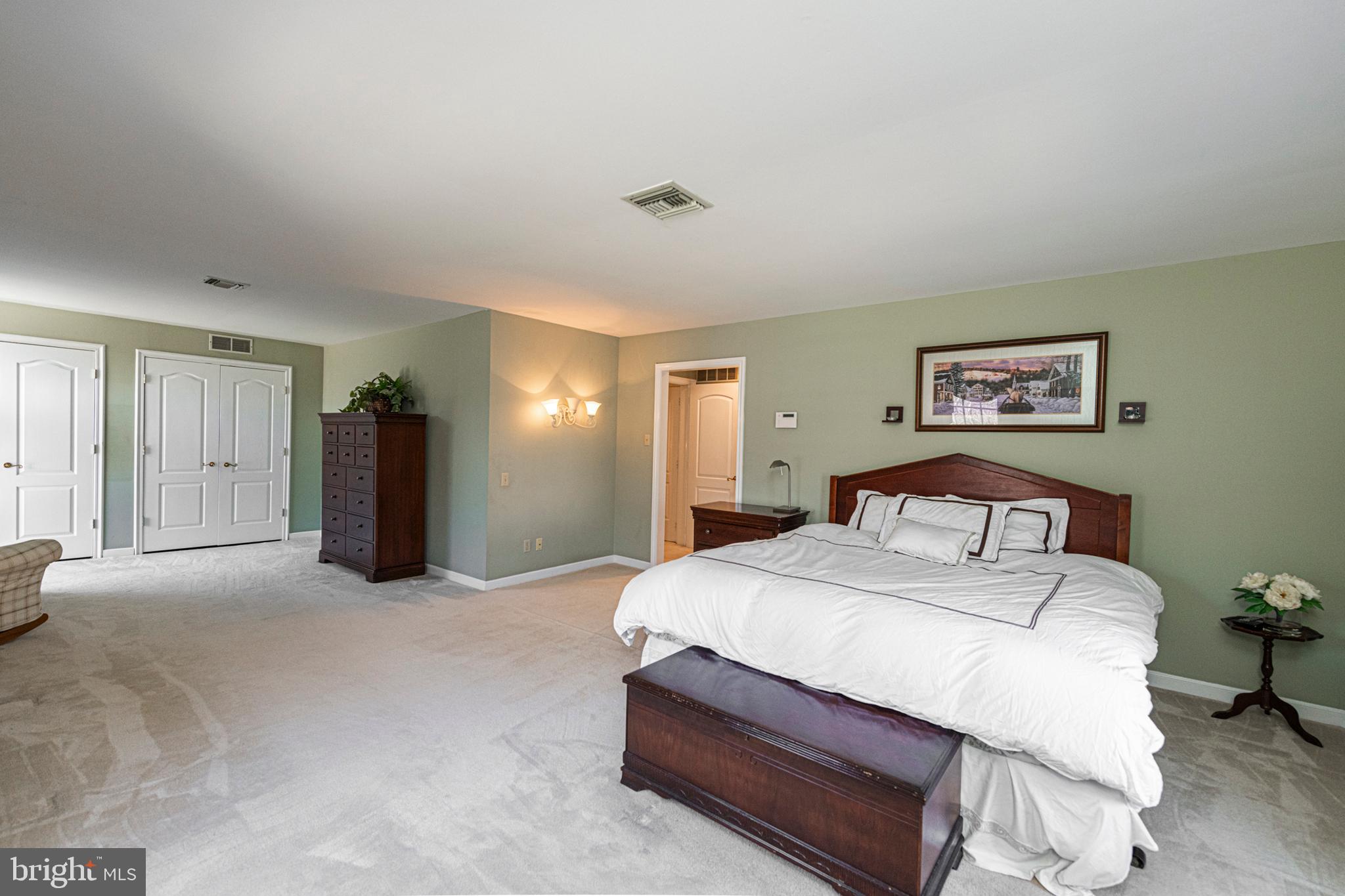 516 Sugartown Road Devon, PA 19333 - Photo 41 of 77 a spacious bedroom with a bed and painting on the wall