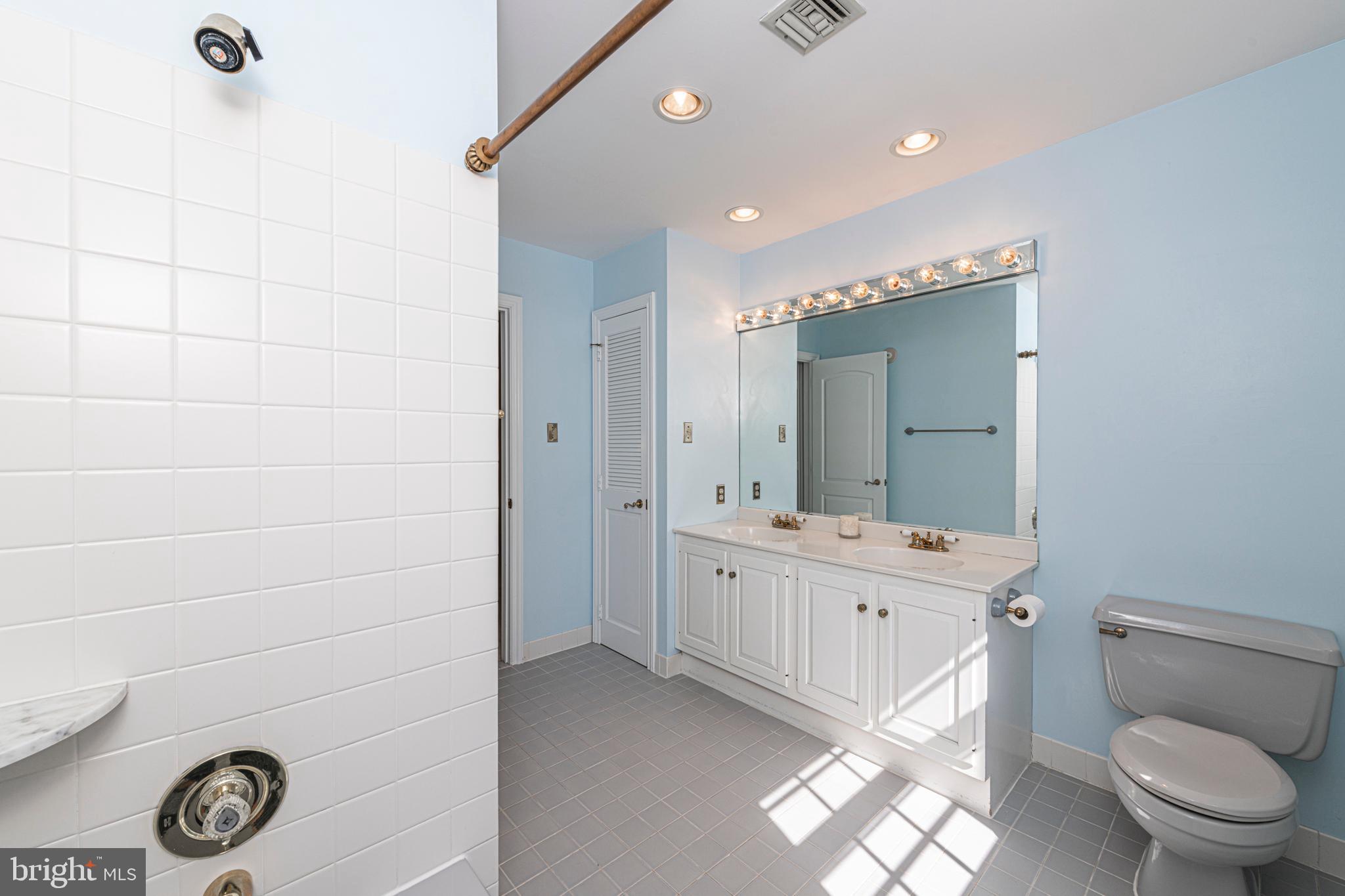 516 Sugartown Road Devon, PA 19333 - Photo 52 of 77 a bathroom with a double vanity sink toilet mirror and shower