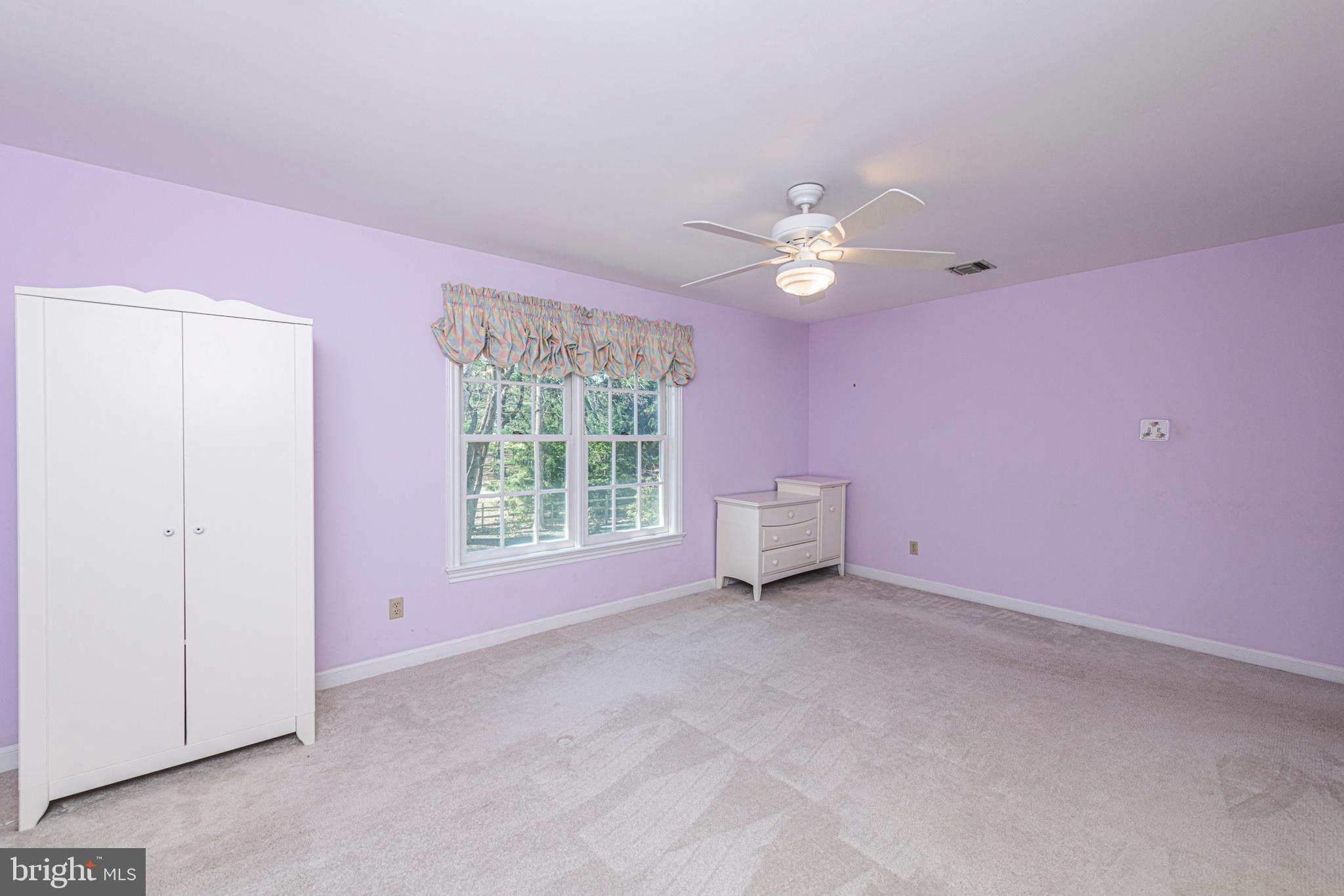 516 Sugartown Road Devon, PA 19333 - Photo 56 of 77 a view of a livingroom with a fan a ceiling fan and a window