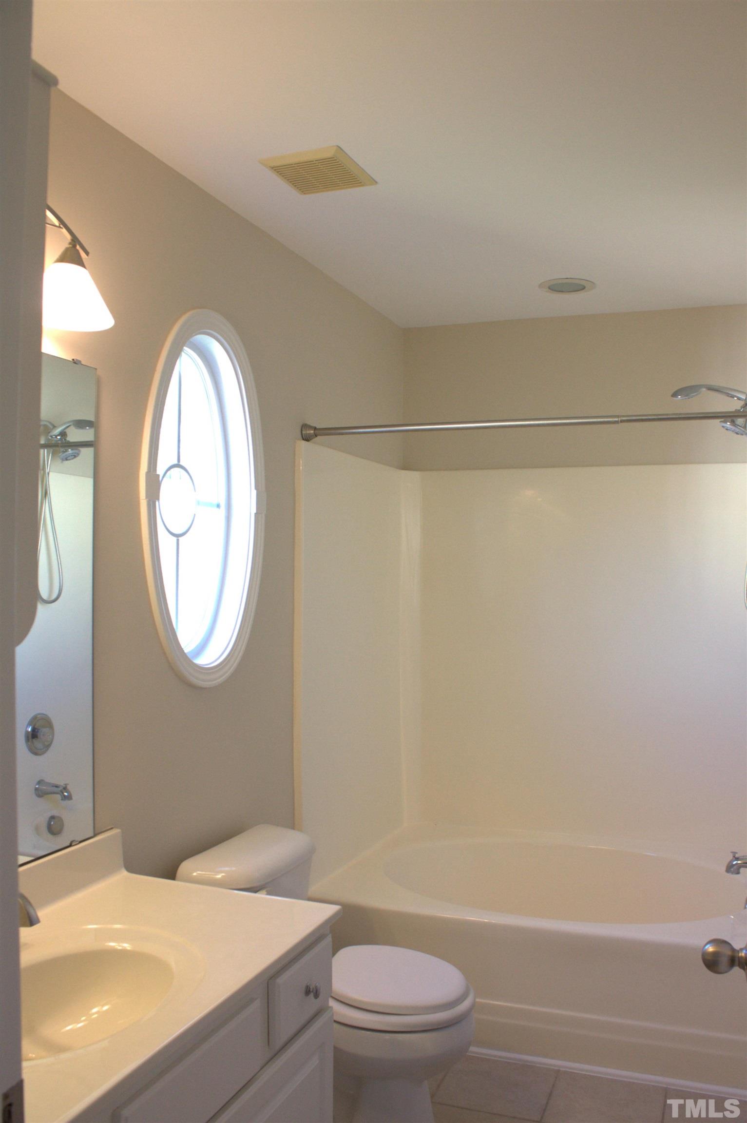 7802 Spungold Street Raleigh, NC 27617 - Photo 12 of 23 a bathroom with a toilet and a mirror
