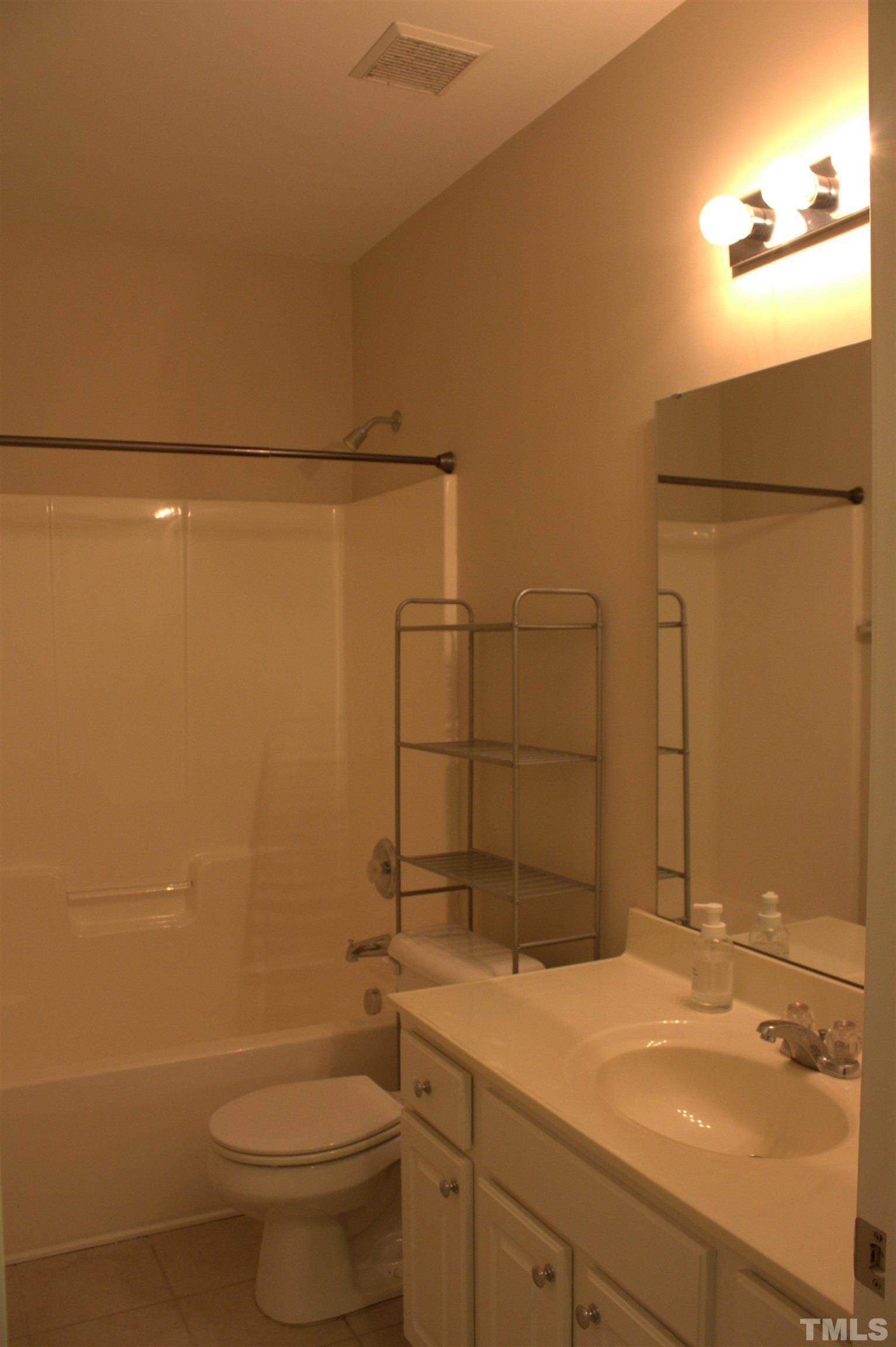 7802 Spungold Street Raleigh, NC 27617 - Photo 18 of 23 a bathroom with a sink a toilet and shower