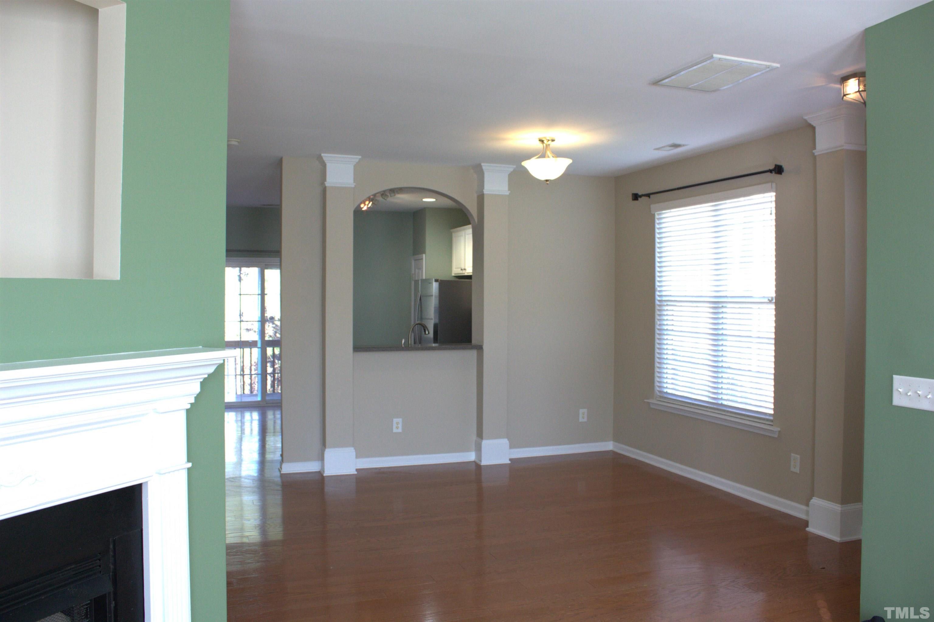 7802 Spungold Street Raleigh, NC 27617 - Photo 6 of 23 a view of an empty room with wooden floor and a window