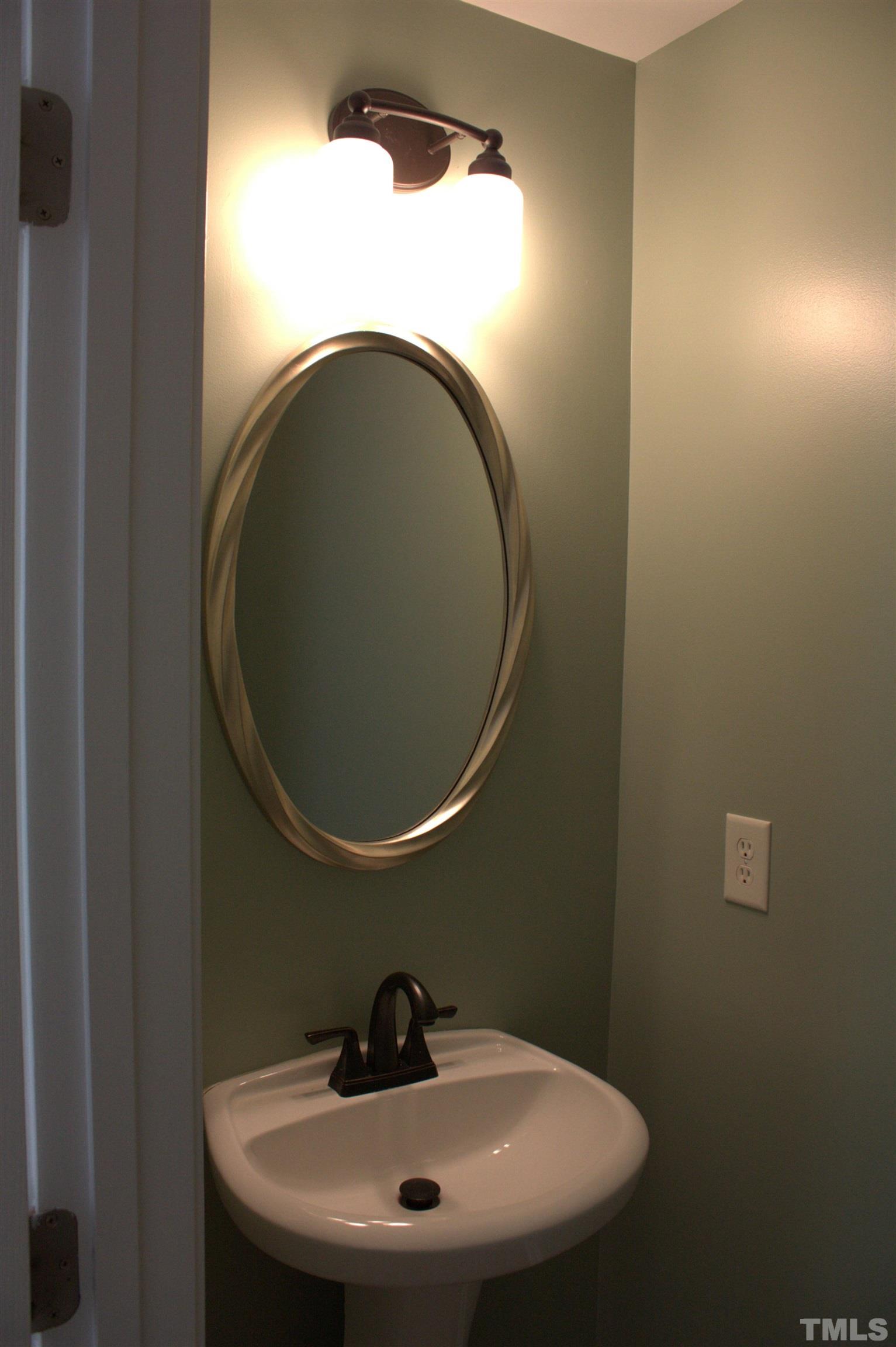 7802 Spungold Street Raleigh, NC 27617 - Photo 8 of 23 a bathroom with a sink and a mirror