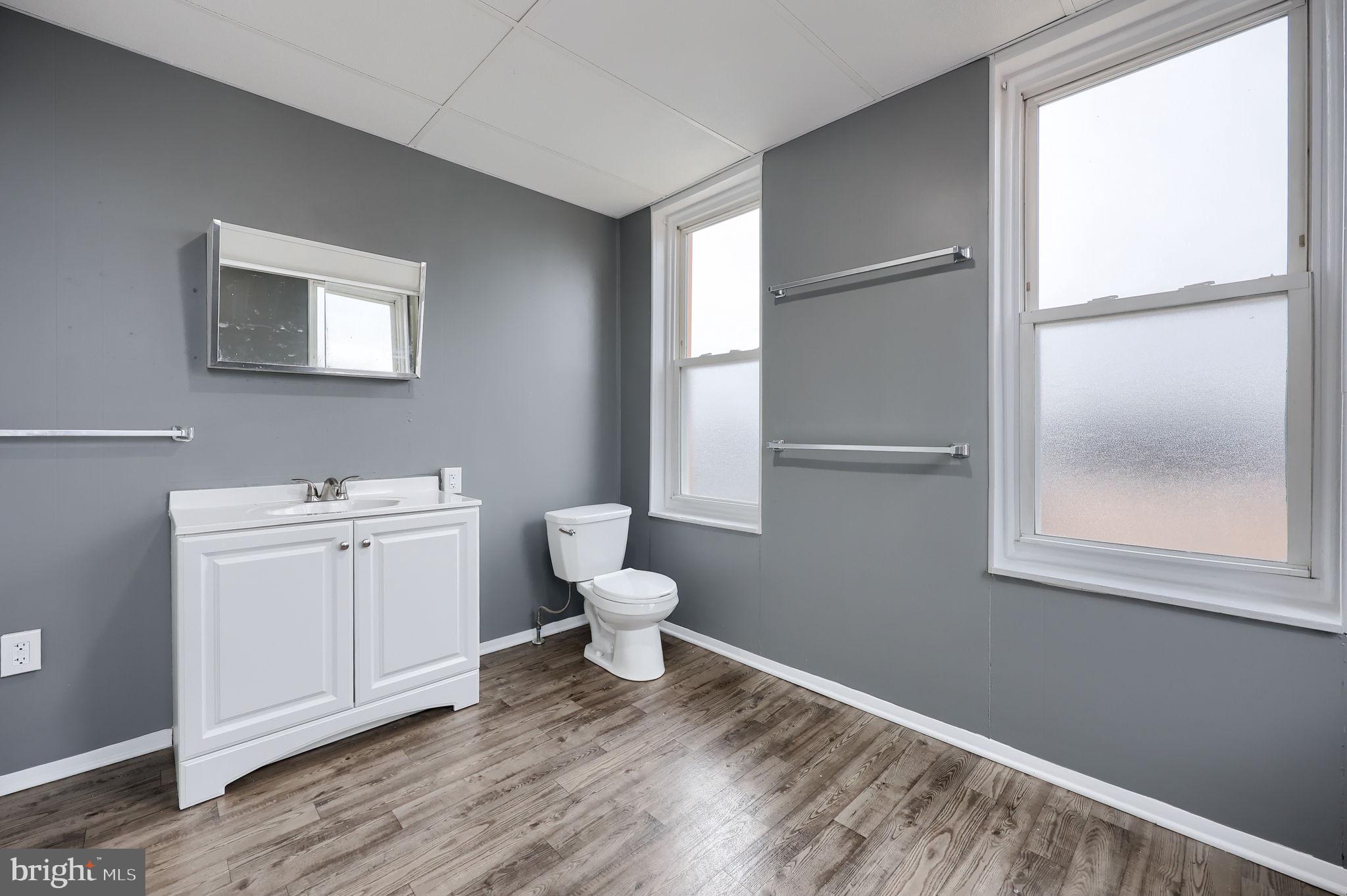 138 South 6th Street Columbia, PA 17512 - Photo 19 of 28 a bathroom with a toilet a sink and a window