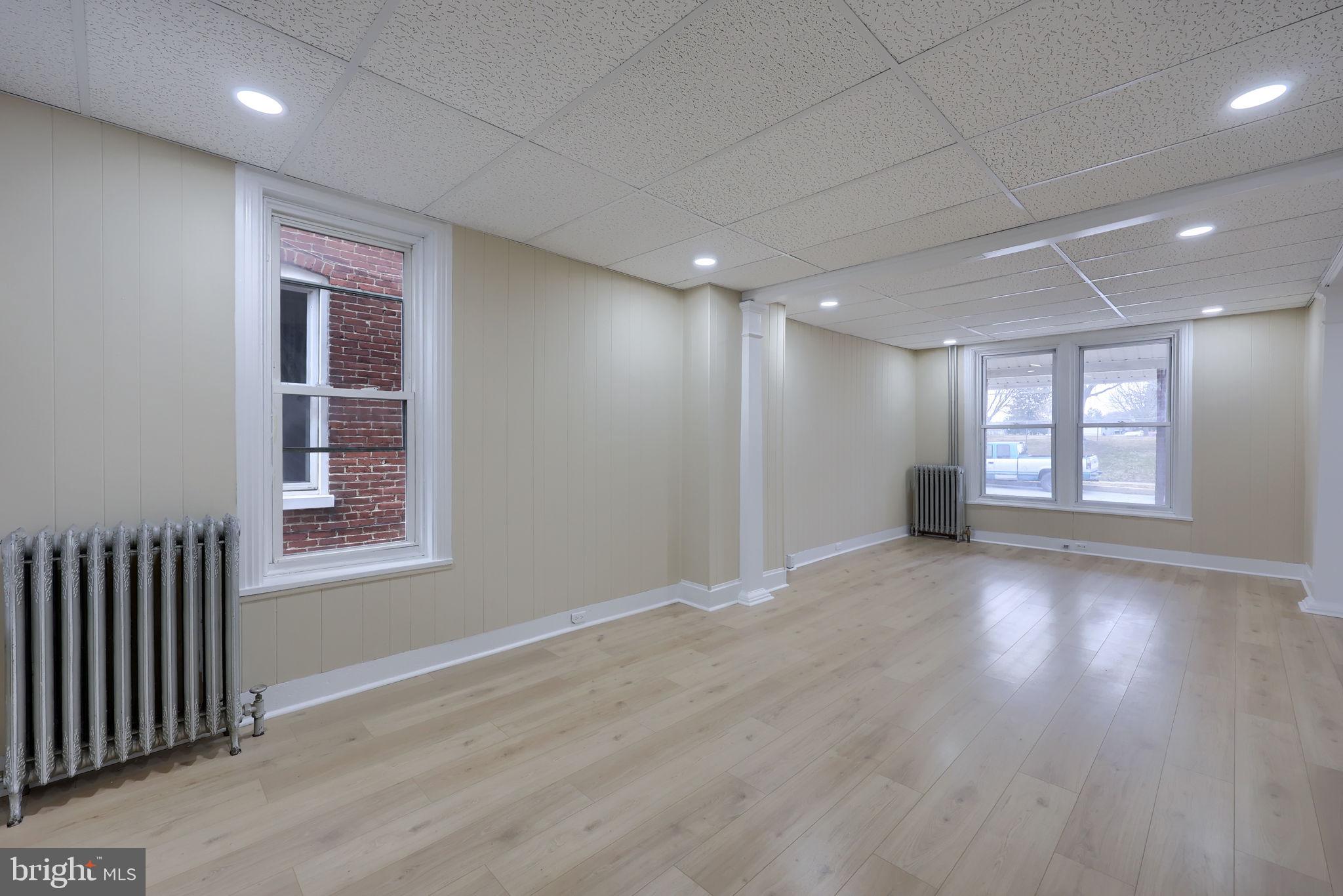 138 South 6th Street Columbia, PA 17512 - Photo 2 of 28 a view of an empty room with wooden floor and a window