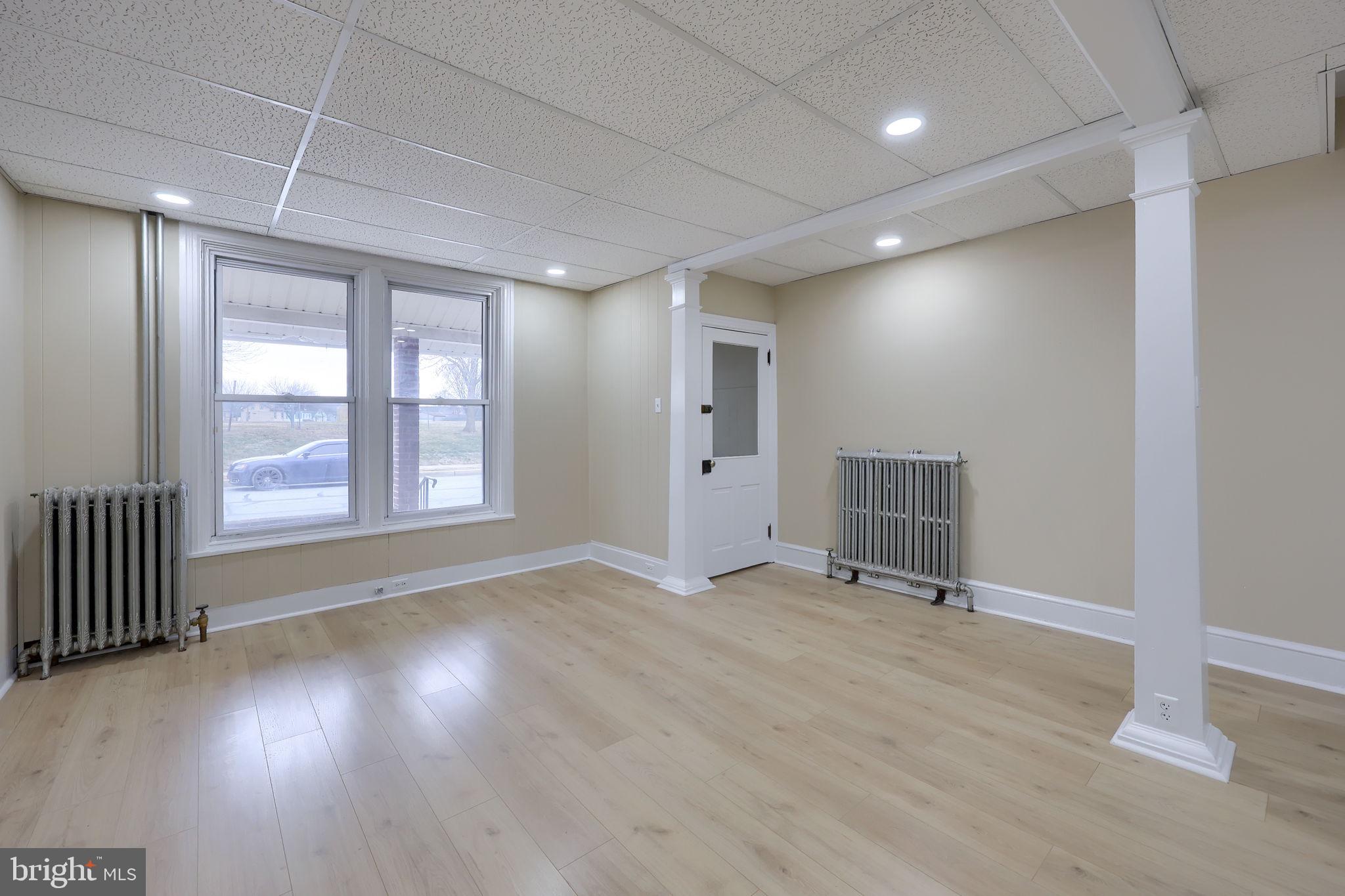 138 South 6th Street Columbia, PA 17512 - Photo 4 of 28 an empty room with wooden floor and windows
