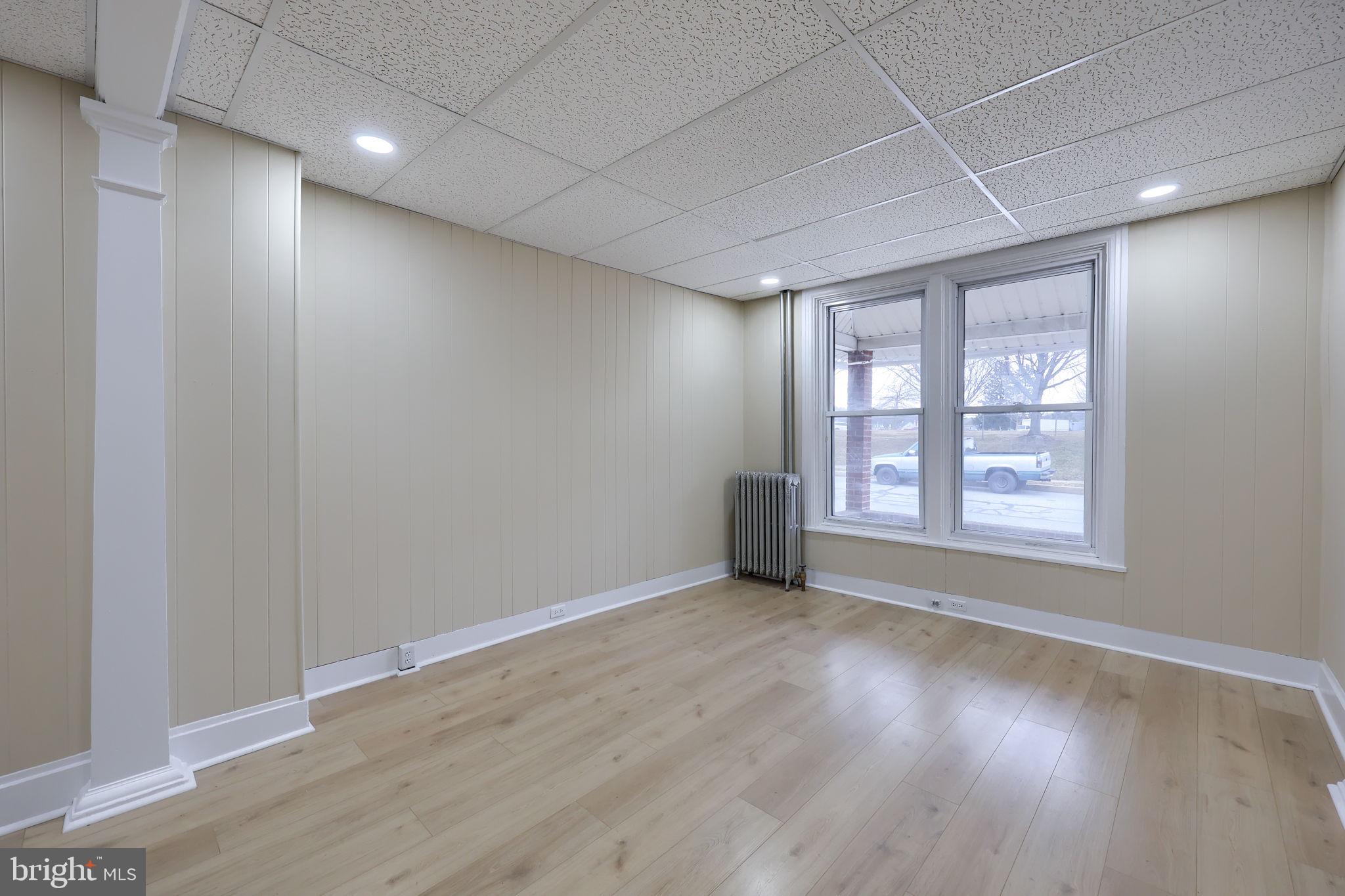 138 South 6th Street Columbia, PA 17512 - Photo 5 of 28 a view of an empty room with wooden floor and a window