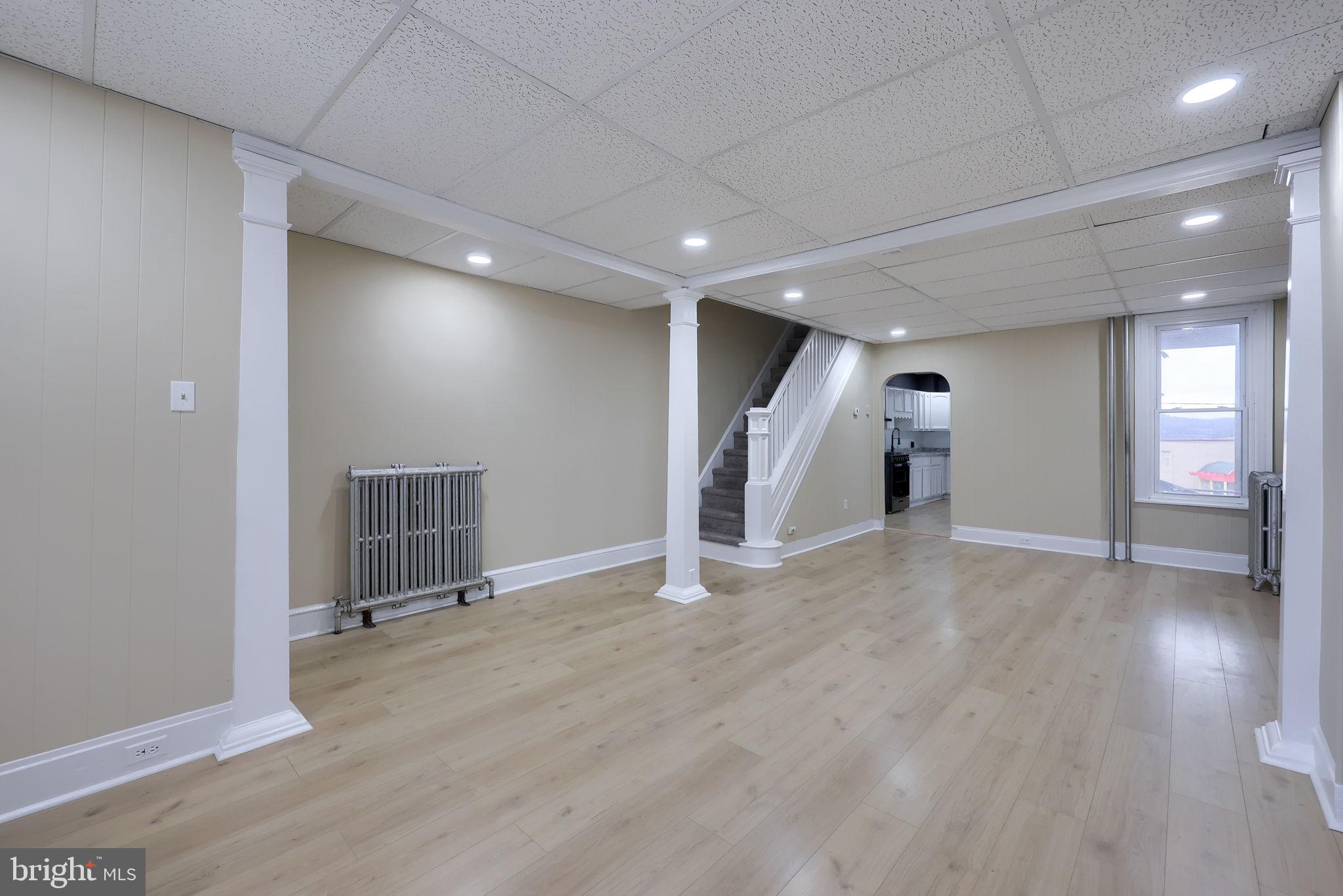 138 South 6th Street Columbia, PA 17512 - Photo 6 of 28 an empty room with wooden floor and windows
