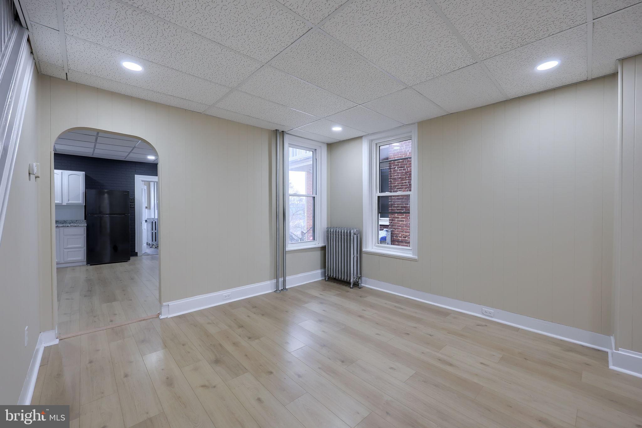 138 South 6th Street Columbia, PA 17512 - Photo 7 of 28 an empty room with wooden floor and windows