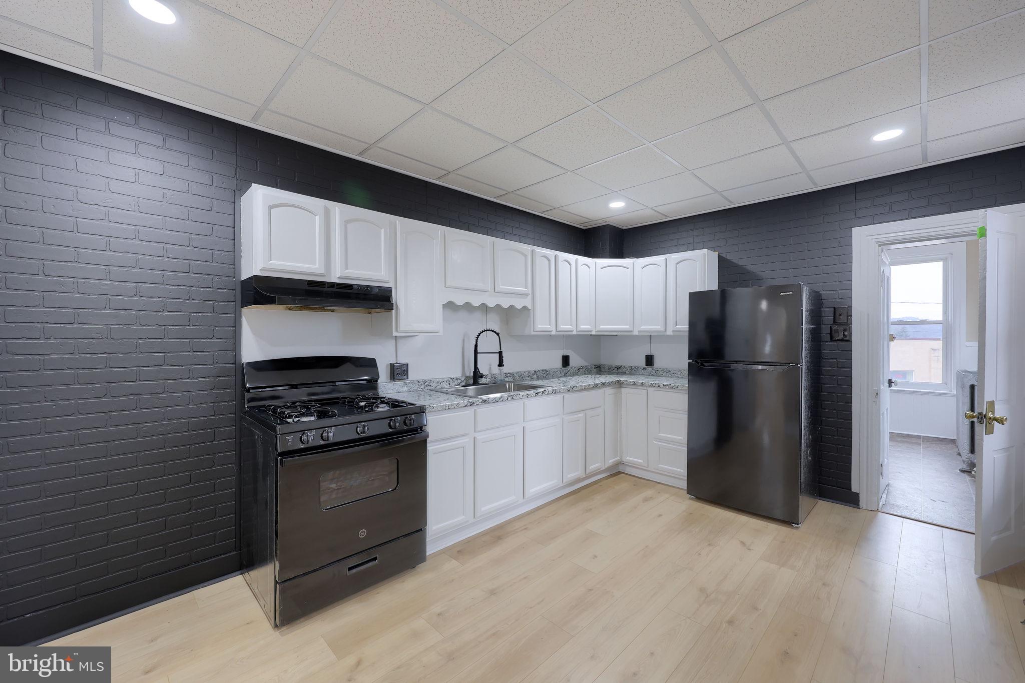 138 South 6th Street Columbia, PA 17512 - Photo 9 of 28 a kitchen with stainless steel appliances granite countertop a refrigerator stove top oven and sink