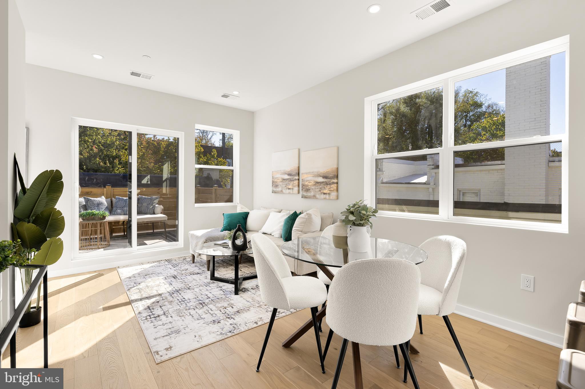 2606 41st Street Northwest, Unit PH Washington, DC 20007 - Photo 1 of 29 a dining room with furniture wooden floor and a rug