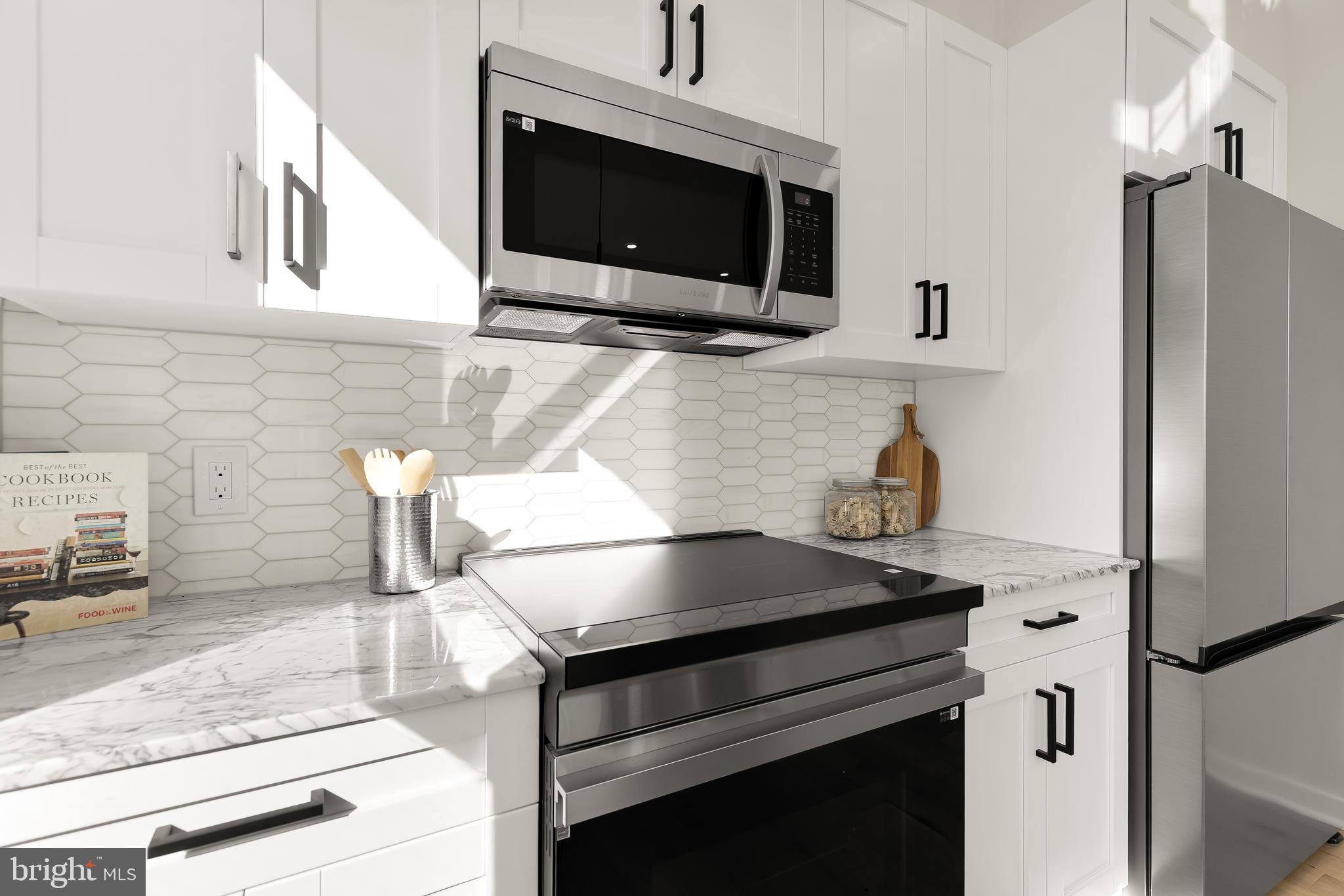 2606 41st Street Northwest, Unit PH Washington, DC 20007 - Photo 12 of 29 a kitchen with granite countertop a stove and a microwave
