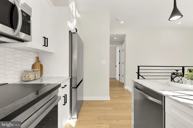 a kitchen with stainless steel appliances a sink and stove