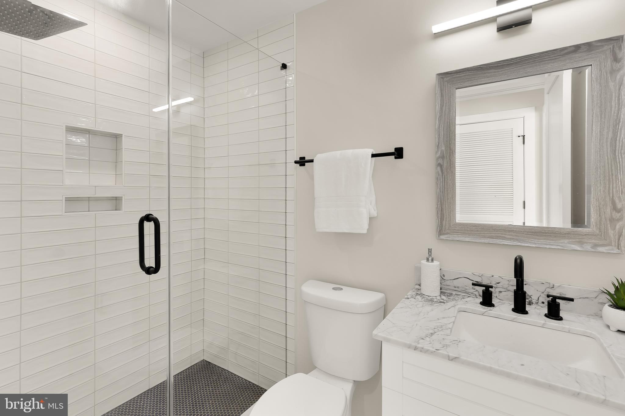 2606 41st Street Northwest, Unit PH Washington, DC 20007 - Photo 19 of 29 a bathroom with a granite countertop sink toilet and shower